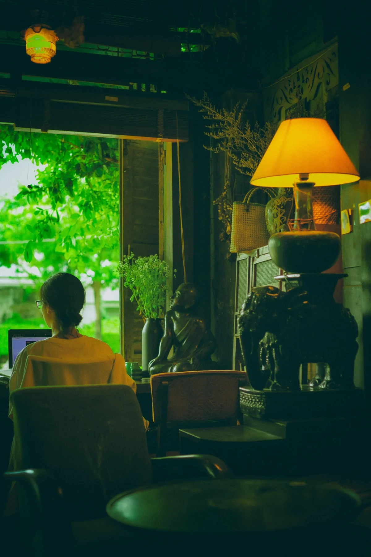 Creative professional working at a desk in a calm green studio